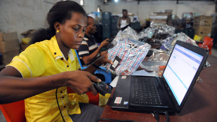 A Jumia worker scans a product at a warehouse in Lagos © AFP